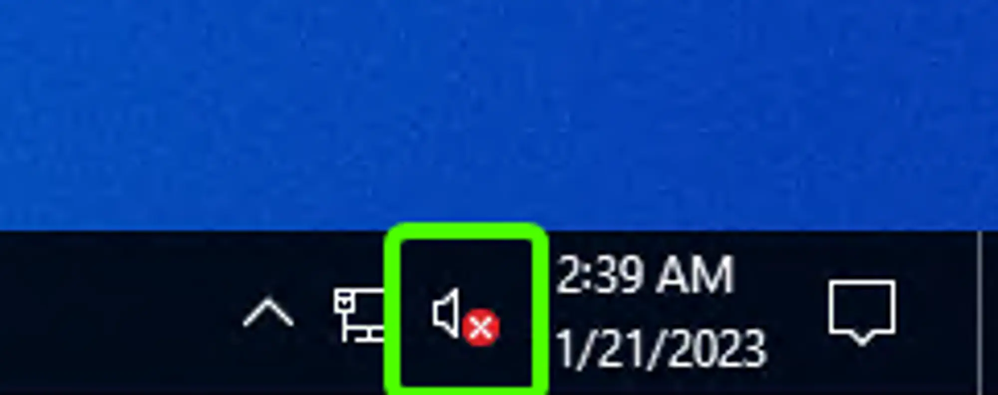 The right side of the Windows task bar, where the notification area is located, with a green box around the Windows sound icon, by default a speaker symbol. It currently has with an X in a red circle on the right side of the speaker symbol, denoting that sound is disabled